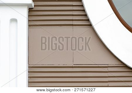 Building Wall Brown Color With Horizontal Stripes, Elements Of  Facade - Pilasters Of Simple Shapes.
