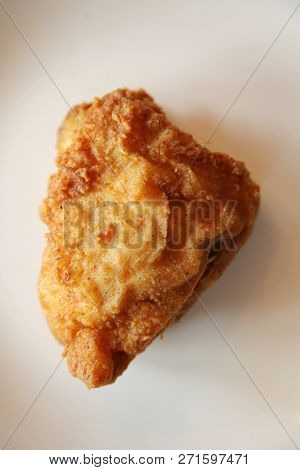 Fried Chicken Breast. Top Down View of a Fried Chicken Breast. Fried Chicken Dinner. Chicken Breast on a white plate. Room for text overlay.

