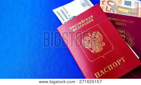 Passports On The Blue Background. Citizenship Of Estonia And Russia. Citizenship Of European Union (