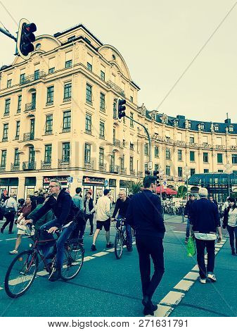 Munich Germany -september 8, 2017; People Crossing Street On Foot And Riding Bicycles  To And From K