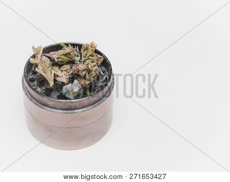 Steel Grinder With Green Cannabis Flower (buds) Inside.