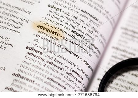 The Word Or Phrase Adequate In A Dictionary Highlighted With Marker.