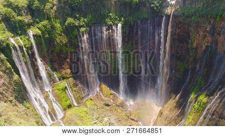 Aerial View Waterfall Coban Sewu In Java, Indonesia. Waterfall In Tropical Forest By Drone Tumpak Se