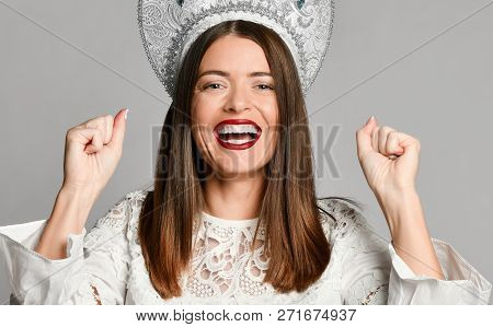 Happy Successful Young Woman Un Russian Traditional Cap Kokoshnik With Raised Hands Shouting And Cel