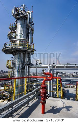 Fireplug To Extinguish The Fire Against The Background Of The Oil Column At The Refinery