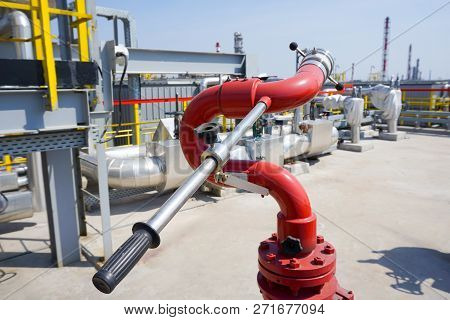 Fireplug To Put Out A Fire Against The Background Of An Installation At An Oil Refinery