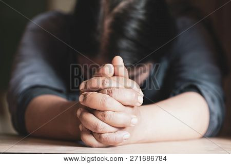 Hands Folded In Prayer On A Holy Bible In Church Concept For Faith, Spirtuality And Religion