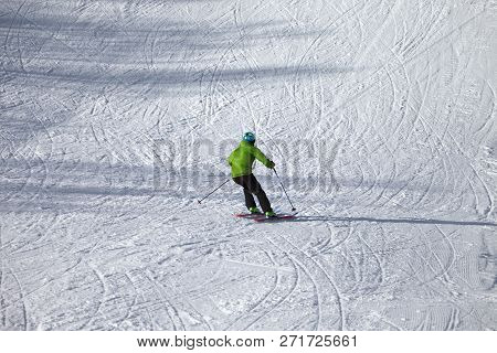 Skier Descent On Snowy Ski Slope With Curves From Skis At Sunny Winter Day. Caucasus Mountains. Hats