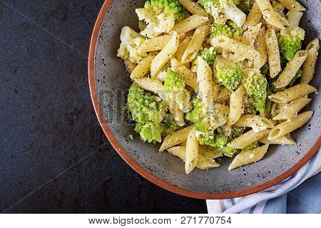 Penne Pasta With Cabbage Romanesco On Black Table. Vegetarian Food. Italian Menu. Top View. Flat Lay