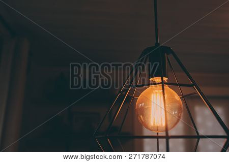 Edison Lamp In Vintage Style Lighting In Evening Home Interior. Earth Hour And Enegry Save Concept.