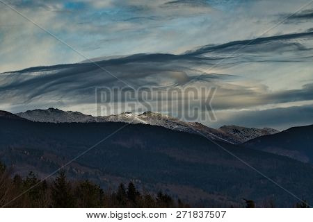 Wind game over clouds over mountain Chopok. Cloudy clouds create beautiful color and shape creations