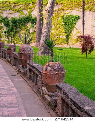 Clay Vase With Flowers In The Cozy Square Of The European City.