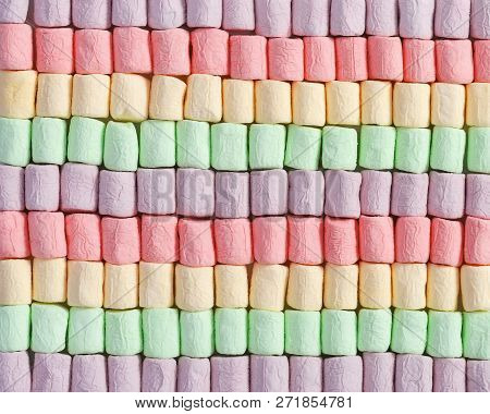 Background From Bright Multicolor Mini Marshmallow. Rows Of Sweet Zephyr. Fon From Marshmallows Clos
