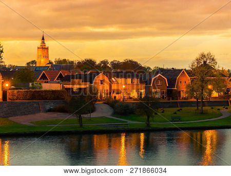 City Skyline Of Leerdam The Netherlands At Sunset With Water And Park View