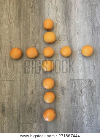 Orange Cross Laid Out On A Laminate Floor