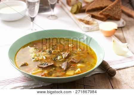 Rassolnik, Traditional Russian Soup, Served With Various Snacks And Vodka. Rustic Style.