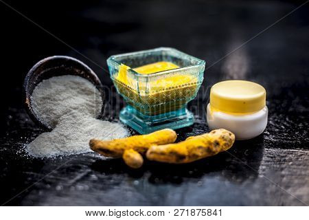 Close Up Of Face Pack Of Rice Flour With Fresh Face Cream And Turmeric Powder On Wooden Surface In A