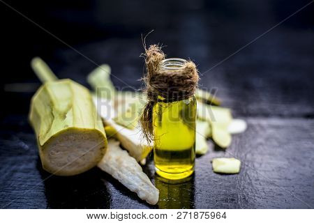 Close Up Of Essential Oil Of Bottle Gourd Or Dudhi Or  Calabash In A Transparent Glass Botlle On Woo