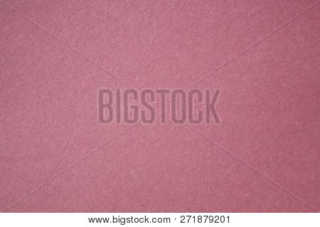 Pink Colored Construction Paper. Close up view of Colored Construction Paper. Backgrounds and Textures. Opacity filter used to lighten and grade the image.


