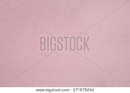 Pink Colored Construction Paper. Close up view of Colored Construction Paper. Backgrounds and Textures. Opacity filter used to lighten and grade the image.


