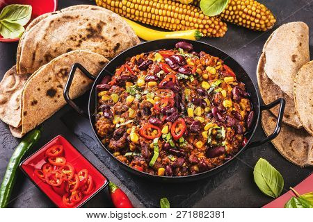 Chili Con Carne In A Clay Bowl On A Concrete Or Stone Rustic Background- Traditional Dish Of Mexican