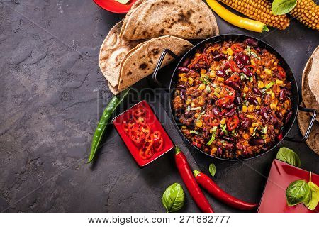 Chili Con Carne In A Clay Bowl On A Concrete Or Stone Rustic Background- Traditional Dish Of Mexican