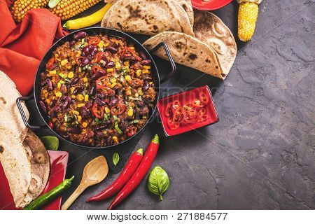 Chili Con Carne In A Clay Bowl On A Concrete Or Stone Rustic Background- Traditional Dish Of Mexican