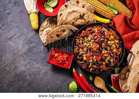 Chili Con Carne In A Clay Bowl On A Concrete Or Stone Rustic Background- Traditional Dish Of Mexican
