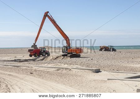 Excavator On The Beach In Norre Vorupor, Denmark, Europe.