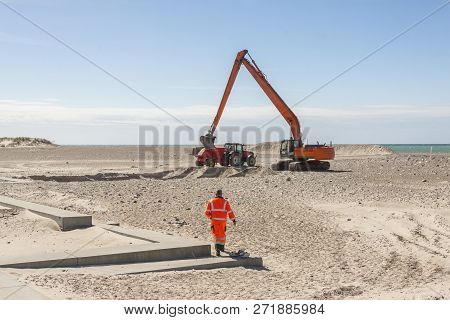Excavator On The Beach In Norre Vorupor, Denmark, Europe.