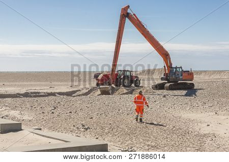 Excavator On The Beach In Norre Vorupor, Denmark, Europe.