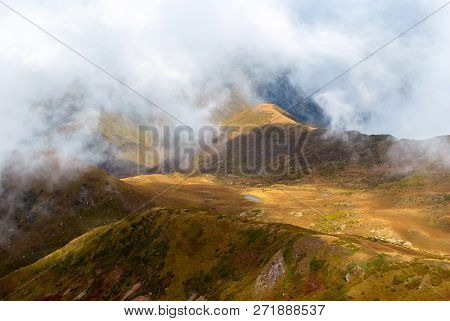 Clouds-covered High Mountain Valley With A Lake, Aerial View