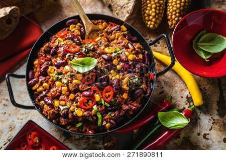 Chili Con Carne In A Clay Bowl On A Concrete Or Stone Rustic Background- Traditional Dish Of Mexican