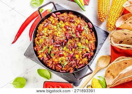 Chili Con Carne In A Clay Bowl On A Concrete Or Stone Rustic Background- Traditional Dish Of Mexican
