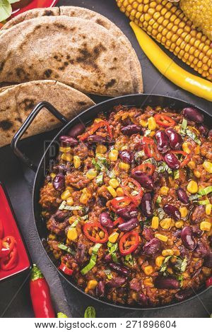 Chili Con Carne In A Clay Bowl On A Concrete Or Stone Rustic Background- Traditional Dish Of Mexican