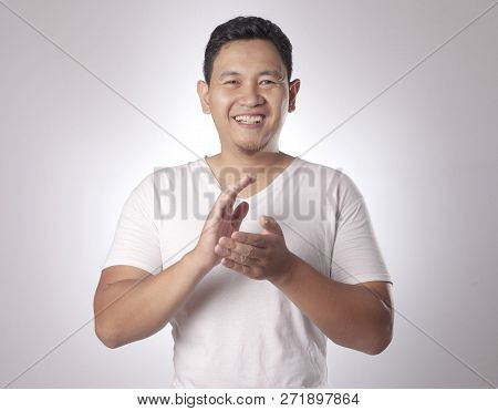 Young Asian Man Wearing White Shirt, Happy Proud Clapping Gesture.over Grey Background, Halfl Body P
