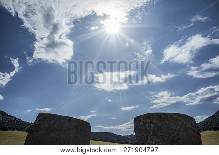 Sun Descending Between Entry Orthostates Of Magacela Dolmen, Extremadura. Spain. Perfect East Orient