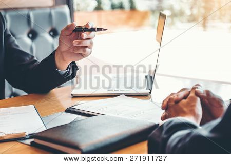 Senior Manager Reading A Resume During A Job Interview Employee Young Man Meeting Applicant And Recr
