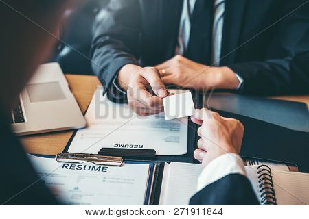 Employee Young Man Exchanging A Business Card To Senior Manager During Job Interview Concept