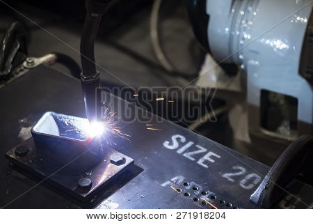The Welding Robot Machine For Welding Automotive Part In The Light Blue Scene.industrial 4.0 Concept