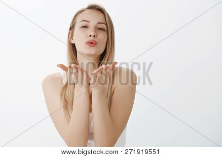 Passionate And Loving Good-looking Tender Girlfriend With Blond Hair Tilting Forward As Folding Lips