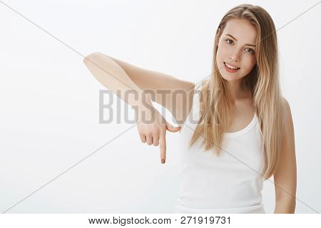 Girl Pressing Button As Pointing Down With Index Finger Smiling Cheerful And Friendly At Camera Show