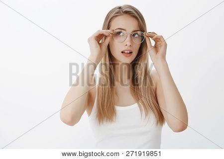 Girl Sees Better As Trying New Prescribed Glasses Ordered In Shop. Portrait Of Intrigued Charming Ca