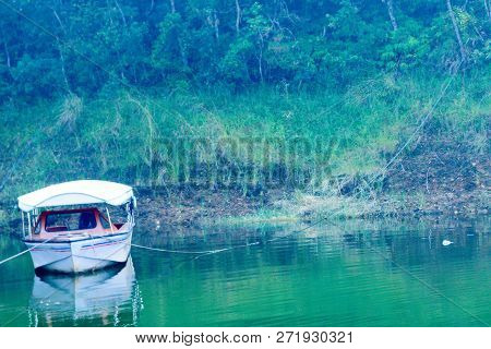 White Wooden Boat At River Bank, Surrounded By Mangrove Forests. River Delta Jungle Cruise. Fisherma