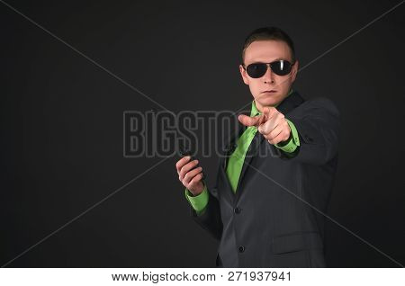 Security Agent With The Portable Radio Station Is Showing Forward By His Index Finger Isolated On Bl