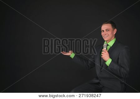 The Leading Show Or Businessman With Microphone In The Hands Is Showing On A Copy Space Isolated On 
