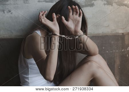 Close-up Of Hands In Handcuff,  Female Prisoner, Arrested Woman Handcuffed Hands. Prisoner Or Arrest