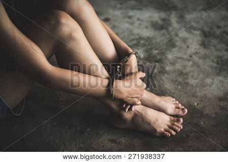 Close-up Of Hands In Handcuff,  Female Prisoner, Arrested Woman Handcuffed Hands. Prisoner Or Arrest