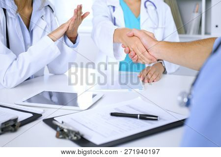 Two Doctors Shaking Hands To Each Other At Meeting. Teamwork And Agreement In Medicine
