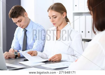 Group Of Business People Or Lawyers Discussing  Terms Of Transaction In Office. Colleagues Working A